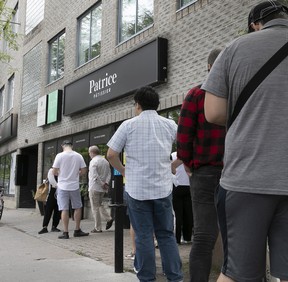 Customers line up outside Patrice Pâtissier to pick up their online orders, Thursday, August 18, 2022, during the last days of the patisserie.