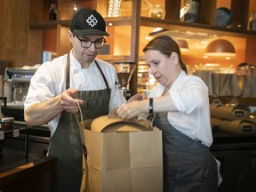 Patrice Demers and Marie-Josée Beaudoin pack up an online order at Patrice Patissier during the final days of the iconic pastry shop.