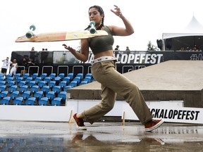 Jihane El Foukahi performs a trick during a rain delay at the Jackalope festival on the Esplanade of the Olympic Park in Montreal Sunday, August 21, 2022.