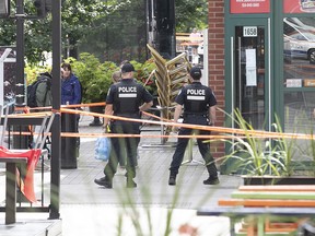 Montreal police at scene of shooting at the corner of St-Denis St. near Emery St. in Montreal on Tuesday, Aug. 23, 2022.