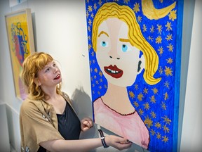 Alana Barrell examines her self-portrait, on display along with dozens of her works, at the CAP Gallery on St-Laurent Blvd.