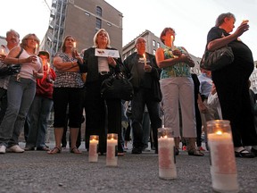 Survivors and family and friends of victims of the Blue Bird Café fire gathered in 2011 for a candlelight vigil. The City of Montreal will commemorate the 50th anniversary of the tragedy on Thursday at the memorial in Phillips Square.