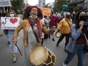 Women march down Ste-Catherine St. in 2021 to denounce violence against women during the Montreal part of the International Women's March.