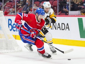 Montreal Canadiens' Jonathan Drouin protects the puck from Pittsburgh Penguins Kris Letang during third period in Montreal on Nov. 18, 2021.