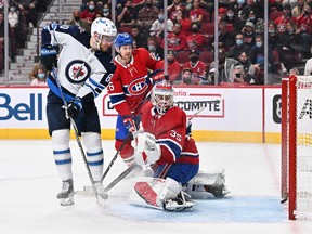 Pierre-Luc Dubois of the Winnipeg Jets watches as Canadiens goalie Sam Montembeault allows a goal during the third period at the Center Bell on April 11, 2022 in Montreal.