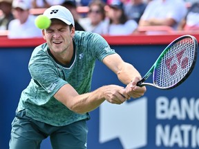 Hubert Hurkacz of Poland hits a return against Casper Ruud of Norway in the semifinals during Day 8 of the National Bank Open at Stade IGA on Saturday, August 13, 2022, in Montreal.