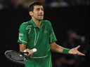This file photo taken on February 2, 2020 shows Serbia's Novak Djokovic in the men's singles final on Day 14 of the Australian Open tennis tournament in Melbourne after a point against Australia's Dominic Thiem It shows how it reacts.