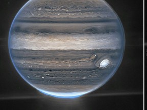 This image obtained from NASA and taken by the James Webb Space Telescope shows Jupiter in a wide-field view, showing the planet with its faint rings, which are a million times fainter than the planet, and two tiny moons called Amalthea and Adrastea.