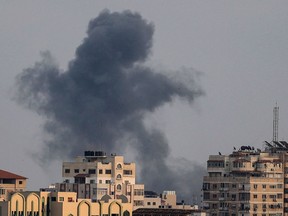 Smoke rises above a building following an Israeli airstrike on Gaza City on August 6, 2022.