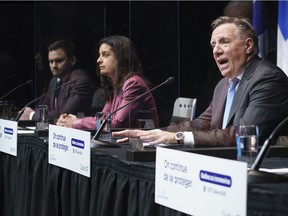 When voters were asked in a recent survey to choose which of five party leaders they would most like to have a coffee or a beer with, Liberal Leader Dominique Anglade and Parti Québécois Leader Paul St-Pierre Plamondon finished last, with only six and four per cent, respectively, well behind Premier François Legault (right).  The three are seen at a December 2020 news conference.