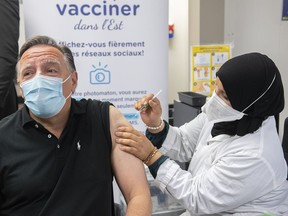 Quebec has begun offering a fifth dose of vaccine against COVID-19 for residents of long-term care homes and private senior residences. Quebec Premier François Legault receives a COVID-19 booster vaccine dose from Kenza Kias in Montreal, Friday, Aug. 5, 2022.