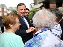 CAQ Leader François Legault speaks with seniors during a campaign stop at a seniors' residence in St-Georges.