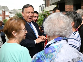 Coalition Avenir Québec Leader François Legault speaks with seniors during a campaign stop at a senior residence, Tuesday, August 30, 2022 in St-Georges Quebec.