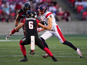 Montreal Alouettes wide receiver Jake Wieneke after a catch while Ottawa Redblacks defensive back Antoine Pruneau defends during the first half in Ottawa on July 21, 2022.