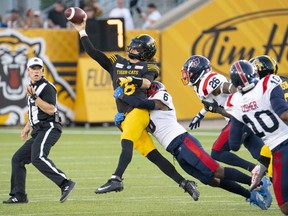 Hamilton Tiger-Cats quarterback Matthew Shiltz (18) tries to throw to prevent the sack by Montreal Alouettes defensive back Adarius Pickett (6) during first half CFL football game action in Hamilton, Ont. on Thursday, July 28, 2022.