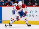 Montreal Canadiens center Nick Suzuki  controls the puck in the first period against the Colorado Avalanche on Jan. 22, 2022.