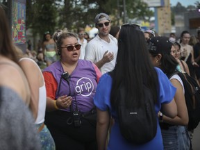 Pamela Binette, GRIP’s festive environment intervention co-ordinator, speaks to attendees of Osheaga on Sunday. GRIP was given the role of the festival’s Hirondelles — intervention workers who educate, listen, help directly, refer or recommend, and offer a safe space.