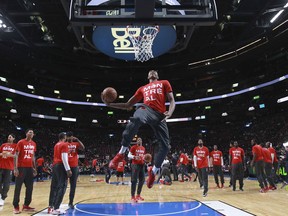 Toronto Raptors players wear Montreal t-shirts while warming up prior to their National Basketball League pre-season game against the Washington Wizards in Montreal Friday Oct. 23, 2015.