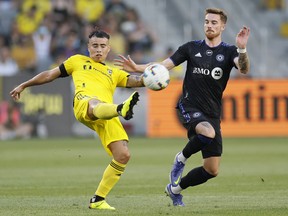 Columbus Crew's Lucas Zelarayan, left, clears the ball past CF Montréal's Joel Waterman during the first half of MLS action in Columbus Wednesday night.