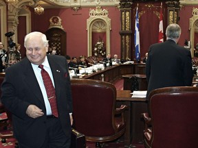 Armand Couture (left) leaves a legislature committee studying the site for Montreal's university hospital (CHUM) as former Quebec premier Daniel Johnson (right) prepares to sit down, Tuesday March 1, 2005 at the Quebec legislature.