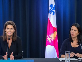 Montreal Mayor Valérie Plante, right, looks on as Quebec Public Security Minister Geneviève Guilbault speaks during a news conference in Montreal, Saturday, August 27, 2022, where she outlined plans to tackle gun violence in Montreal.