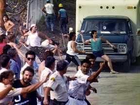 A mob throws rocks at Mohawk women, children and elders on Aug. 28, 1990.