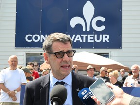 Quebec Conservative Leader Eric Duhaime responds to reporters at his campaign launch rally, Sunday, August 28, 2022 in Quebec City.