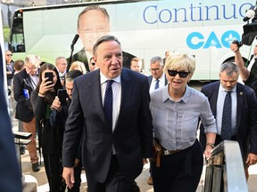 Coalition Avenir Québec Leader François Legault  walks to the lieutenant-governor's office, accompanied by his wife Isabelle Brais, to call a general election Sunday, August 28, 2022  in Quebec City. Quebecers are going to the polls on Oct. 3.