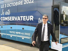 Conservative Party of Quebec Leader Éric Duhaime walks from his bus to submit his candidacy nomination papers in Wendake for the Oct. 3 general election.