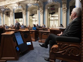 Quebec Premier François Legault, left, delivers the inaugural speech, Tuesday Oct. 19, 2021, at the legislature in Quebec City. Speaker Francois Paradis, right, looks on. Far more women than men are saying goodbye to the Quebec legislature ahead of the fall election by announcing they won't run for another term.