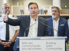 Federal Public Safety Minister Marco Mendicino speaks during a news conference alongside Canadian Heritage Minister Pablo Rodriguez, right, and Station 49 Police Chief Emmanuel Anglade in Montreal, Thursday, August 4, 2022, where he announced federal support for organizations on the front lines of the fight against gun and gang violence in Quebec.
