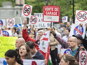 People take part in a protest against Bill 96 in Montreal on May 26, 2022. A Quebec Superior Court judge has temporarily struck down two articles of the province's new language law, saying they could prevent some English-speaking organizations from accessing justice through the courts.