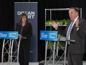 Quebec Premier Francois Legault speaks on investments in green technology and bio food suppliesas as Quebec Minister for Regional Economic Development Marie-Eve Proulx, left, looks on, at the Ocean Vert plant, in Saint-Pacome, Que., Friday, Oct. 29, 2021.