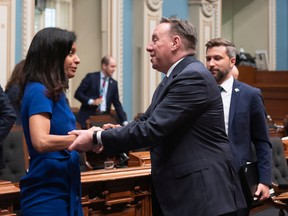 Quebec Premier Francois Legault, centre, shakes hand with Quebec Liberal Leader Dominique Anglade, left, as Quebec Solidaire Leader Gabriel Nadeau-Dubois, right, looks on, at the end of the 42nd legislature on June 10, 2022