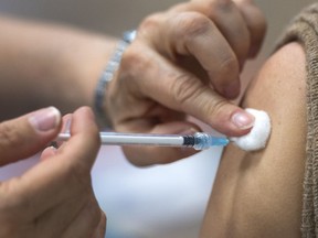 A person gets the Pfizer COVID-19 vaccination at a mobile clinic, Friday, April 30, 2021, in Montreal.