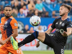 CF Montréal's Djordje Mihailovic, right, vies for control of the ball as New York City FC's Alexander Callens moves in during first half in Montreal on July 30, 2022.
