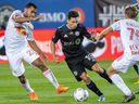 CF Montréal's Joaquin Torres breaks away from Red Bulls' Cristian Casseres Jr., left, and Daniel Edelman during first-half action at Stade Saputo Wednesday night.