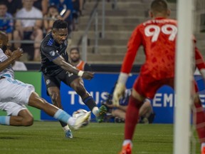 CF Montreal's Romell Quioto drives the ball to the net of New England Revolution goalie Djordje Petrovic during first half MLS soccer action in Montreal on Saturday, August 20, 2022.
