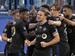 CF Montréal midfielder Romell Quioto (30) celebrates with midfielder Samuel Piette (6) and teammates after scoring a goal against the Inter Miami CF during the first half at Saputo Stadium on Aug. 6, 2022.