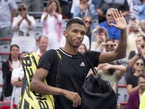 Canada's Felix Auger-Aliassime walks off the court after losing to Casper Ruud of Norway for his win in quarterfinal play at the National Bank Open tennis tournament, Friday, August 12, 2022 in Montreal.