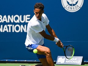 Gabriel Diallo hits a shot against James Duckworth in first-round qualifying play at IGA Stadium on Saturday, August 6, 2022.