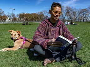Throwback weather, as Wednesday will be delightfully springlike: Gerardo Bedouin and his dog, Maya, relax with a book at Jeanne-Mance Park in May 2022.
