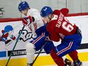 Juraj Slafkovsky, right, and Ryan Hopkins battle for puck during the Montreal Canadiens' evaluation camp at the Bell Sports Complex in Brossard on July 11, 2022.