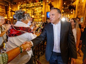 François Legault shakes hands with supporters while campaigning in Vaudreuil-Dorion, west of Montreal, on Sept. 3, 2022.