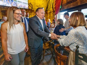 Coalition Avenirs Québec leader François Legault is accompanied by local candidate Eve Bélec, left, as he campaigns in Vaudreuil-Dorion, on Sept. 3, 2022. Bélec is running in the Vaudreuil riding in the upcoming Québec provincial election.