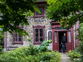 Rob Sibthorpe and his curly-coated retriever, Maggie, at the front of the Goode house, the Westmount property he owns with Lesley Pahl.