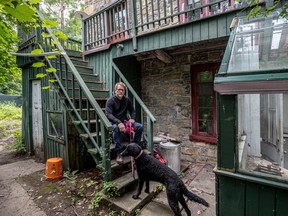 The Goode house owner Rob Sibthorpe and his curly-coated retriever, Maggie, at the rear of his Westmount property Sept. 5, 2022.