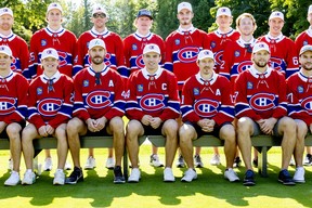 New Montreal Canadiens captain Nick Suzuki is flanked by assistant captains Joel Edmondson, left, and Brendan Gallagher while sitting for a team photo at their annual golf tournament in Laval, on Sept. 12, 2022.