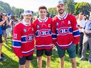 Nick Suzuki stops for a photo after being named the new captain of the Montreal Canadiens with co-captains Brendan Gallagher, left, and Joel Edmondson at the team's annual golf tournament in Laval on September 12, 2022.