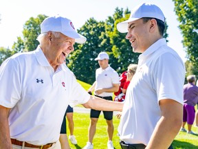 Former Canadiens captain and Hall of Famer Yvan Cournoyer speaks with new team captain Nick Suzuki at team’s golf tournament Monday at Laval-sur-le-Lac.